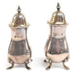 MARTIN, HALL & CO; a cased pair of Victorian hallmarked silver peppers with crimped rims, each