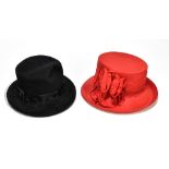 CAROLINE CHARLES; a black wool felt hat with ribbon and mesh detail, and a large red silk hat with