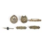 Six late 19th/early 20th century silver brooches including a horseshoe shaped example, a cylindrical