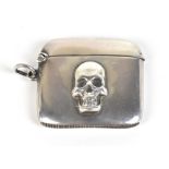 HENRY MATTHEWS; a George V hallmarked silver vesta case with applied skull decoration, Birmingham