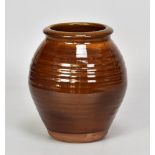 Attributed to BERNARD LEACH (1887-1979) for Leach Pottery; a slipware jar with pronounced ribbing