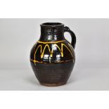 MICHAEL CARDEW (1901-1983) for Winchcombe Pottery; a slipware jug with trailed decoration on black