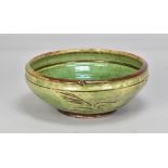 Attributed to MICHAEL CARDEW (1901-1983) for Winchcombe Pottery; a slipware bowl covered in green