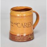 MICHAEL CARDEW (1901-1983) for Winchcombe Pottery; a slipware calligraphic tankard partially covered