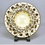 GORDON FORSYTH (1879-1952); a white earthenware charger, copper lustre on honey glaze, painted mark,