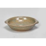 KATHARINE PLEYDELL-BOUVERIE (1895-1985); a lugged stoneware dish partially covered in grey/green