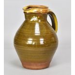 Attributed to BERNARD LEACH (1887-1979) for Leach Pottery; a large slipware jug with yellow slip