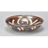 URSULA MOMMENS (1908-2010); a stoneware dish with wax resist decoration, impressed UD mark, diameter