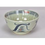 BERNARD LEACH (1887-1979); a stoneware bowl covered in celadon with underglaze blue and red