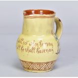 EDWIN BEER FISHLEY (1832-1912) for Fremington Pottery; a small slipware jug covered in pale yellow