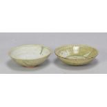 URSULA MOMMENS (1908-2010); a pair of stoneware bowls covered in green ash glaze with incised