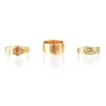 Two hallmarked 9ct gold rings to include a thin buckle ring, size M, a half hoop with dolphins,