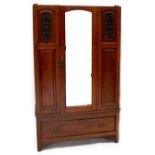 An Edwardian mahogany single mirrored door wardrobe, carved floral panel to either side of door,