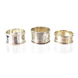 Three early 20th century hallmarked silver napkin rings, combined approx 1.5ozt (3).