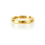 A 22ct gold wedding band, size K, stamped 22, maker's mark indistinct, Sheffield 1910.