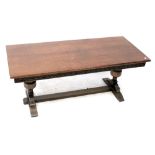 A JC reproduction oak coffee table with carved apron on bulbous stretchered supports,