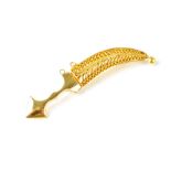 A bright yellow metal brooch in the form of a Middle Eastern dagger,