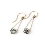 A pair of Edwardian diamond cluster earrings, the flower head inset with seven tiny diamonds,
