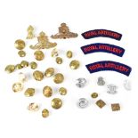 A group of Royal Artillery related items to include two badges and two shoulder flashes,