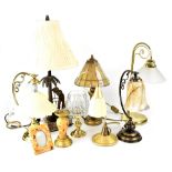 A quantity of various table lamps to include a pair of brass lamps with carved arms and tulip