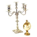 A plated four-branch candelabrum with central sconce, shell motifs on a stepped base,