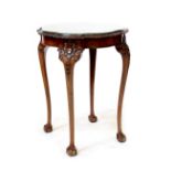 A Georgian-style mahogany side table with scalloped top and carved detail,