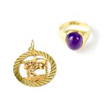 A 9ct gold 'Taurus' necklace pendant and a 9ct gold fashion ring set with purple cabochon, size N,