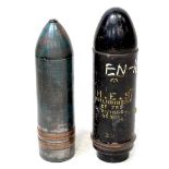 Two examples of artillery shell projectiles, one marked '105mm TK SX 689', the other marked 'H.E.