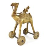 A late 19th/early 20th century children's toy in the form of an Asian brass 'pull-along' camel,