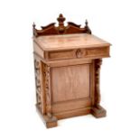 A reproduction oak and burr walnut Davenport with broken swan neck pediment and gallery top,