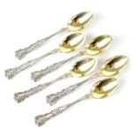 Six small sterling silver teaspoons with fancy floral handles and gilt bowls, marked Sterling,