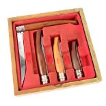 An Opinel shop counter display knife set comprising four country pursuit knives of graduated sizes,