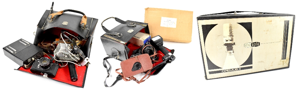 Various cased and uncased cameras to include a Zeiss Ikon, a Toshiba flash, a Super-Takumar 1.