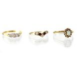 An 18ct gold three-stone diamond illusion set ring, size L/M and two 9ct gold fashion rings,