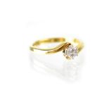 An 18ct gold crossover diamond solitaire ring, the brilliant cut approx 0.25ct, size N, approx 3.5g.