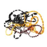 Various vintage glass necklaces to include amber coloured, black and clear beads,