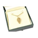 A 9ct gold flat curb necklace with tiny diamond set leaf pendant, length approx 50cm, approx 3.2g.