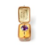 An 18ct gold ring set with oval faceted amethyst,