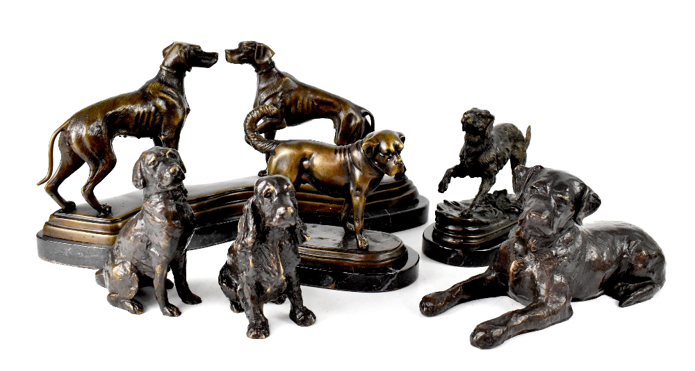 Five bronzed dog figures to include a pair on a bronzed stand,