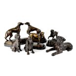 Five bronzed dog figures to include a pair on a bronzed stand,