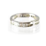 A white gold diamond eternity ring set with thirty small baguette cut diamonds, size O.