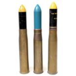 Three 105mm brass artillery shell cases, each with a 105mm 'TK SK689' projectile,