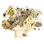 A bag of various items of costume jewellery.