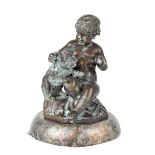 A bronze figure of a young child with puppy, on a stylised grassy plinth to circular marble base,