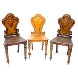 Three Victorian shield back hall chairs with tapering turned supports to peg feet (3).