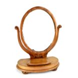 A late 19th/early 20th century freestanding oval swing dressing table mirror,