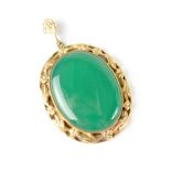 A 9ct gold oval necklace pendant with light green stone set within a 9ct gold leaf and berries