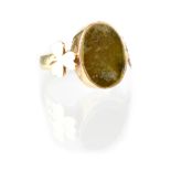 A 9ct gold gentlemen's ring set with oval green onyx with three leaf clover shape shoulders,