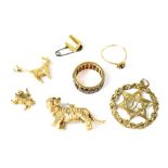 Three 9ct gold charms to include a large tiger, a cat, a small lion and a cup,
