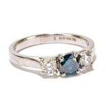 A platinum and diamond three stone ring, the central fancy, blue tinted diamond approx 0.
